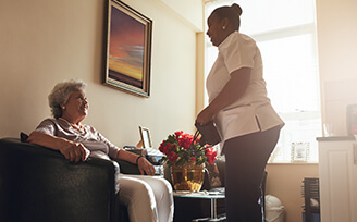 Young nurse talking to older woman