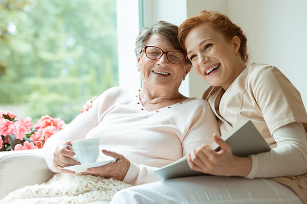 Older woman laughing with younger woman